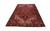 Angled floor view of this large hand-knotted Heriz rug showing dark navy main border and ivory corners