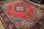 Angled view showing scalloped red field, cornflower blue spandrels and ivory guard border detail