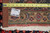 Back of the 10x12 Sarouk rug with tape measure showing tight hand-knotted wool weave
