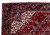 Close-up corner showing navy turtle palmette border and ivory spandrel of this Persian village rug