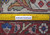 Back of 10x13 Tabriz rug with ruler showing hand-knotted wool weave and knot density