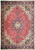 Red field Persian Tabriz rug with navy octagonal medallion, ivory spandrels and floral navy border