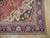Corner detail showing ivory spandrel, dark green serrated leaves and navy vase border pattern