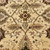 Detail of camel palmette motif framed by olive vine scroll and small pink flowering sprays