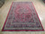 Traditional 6x10 Persian area rug in cherry red with multi-band ivory and navy border