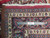 Back of the Sarouk rug with ruler, showing hand-knotted wool weave and ivory fringe