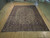 9'4" x 12'8" Kashan rug laid flat on light wood floor showing full ivory field
