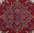 Close-up of the stepped geometric medallion in deep red, navy and ivory wool