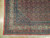 Corner detail showing ivory turtle border, coral guard stripes, cotton fringe and tight Kurdish knotting