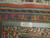 Ruler and Authentic Handmade label on the border proving hand-knotted wool pile and fine knot density