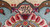 Woven signature cartouche in the border, hand-knotted script above a red and cream rosette