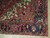 Corner detail of indigo main border, olive guard stripes and ivory spandrel on wool pile