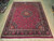 10' x 12'2" Persian Mashad rug laid flat on light wood floor showing full design