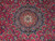 Close-up of layered ivory and navy medallion with blue palmettes on raspberry red wool field