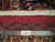 Reverse of hand-knotted Mashad rug with ruler and Authentic Handmade label showing tight wool weave