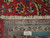 Back of the 9'6" x 12'10" Tabriz rug with ruler showing hand-knotted wool weave density