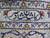 Woven signature cartouche in the border, navy Persian script on ivory hand-knotted wool