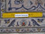 Ruler on the back proving fine hand-knotted wool weave of this 9'6" x 13'2" Kashan
