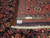 Reverse side and fringe with ruler showing hand-knotted wool weave and authentic handmade inventory tag