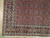 Corner detail showing multi-band border, cream guard stripes and dense knotting on this Persian rug