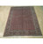 Salmon red Bijar rug displayed on light hardwood floor showing dark turtle palmette main border