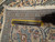 Folded corner with ruler laid across the border, used to gauge knots per square inch