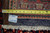 Back of the 9'8" x 13'2" Tabriz rug with tape measure, inventory tag and cotton fringe
