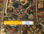 Ruler close-up of hand-knotted wool pile showing knot density and authentic handmade label