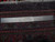 Reverse of the Tabriz rug with ruler and Authentic Handmade tag showing tight even knotting