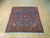 Blue and red hand-knotted wool Sarouk square rug displayed flat on light wood flooring
