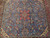Close-up of the coral 8 petal rosette medallion and flowering sprays on sky blue ground