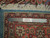 Reverse of the square Persian rug with ruler, ivory cotton fringe and Authentic Handmade label