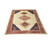 Large 10x13 Persian village rug at an angle showing salmon medallion and multi band borders