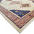 Corner detail showing navy blue spandrel, tribal motifs, layered salmon borders and ivory fringe