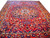 Full view of 9'9 x 12'8 Persian Bakhtiar rug with navy medallion on brick red field