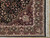 Corner detail showing ivory guard bands, green border cartouches and hand-tied cream fringe