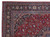 Close-up corner detail of hand-knotted Khorasan rug showing palmette border, guard stripes and ivory fringe