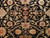 Close-up of salmon rosettes, sage leaves and gold arabesque vines on the black wool field