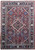 Brick red Persian Heriz rug with navy border, ivory diamond medallion and all over floral lattice