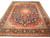 Full overhead view of 9'6" x 14' Persian Kashan rug with navy field and red medallion