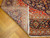 Folded corner revealing tight hand-knotted back, ivory fringe and visible knots per square inch