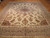 9'11" x 13'8" Kerman rug on parquet floor, ivory field inside wide paisley border