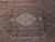 Close-up of ivory hexagonal medallion surrounded by navy field with gold rosettes and fish motifs