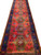17 foot long Persian runner at an angle showing stepped medallions and royal blue border