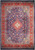 Overhead view of navy blue Sarough rug with rust red border and ivory floral medallion center
