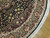 Ivory and burgundy border detail with soft cotton fringe along the curved edge of this rug