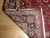 Back of the 10x13 Mashad rug folded over to reveal tight knotting and cotton foundation