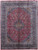 9'10" x 12'10" red Persian Kashmar rug with navy floral border and ivory medallion