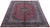 Angled floor view of the 10x13 Kashmar rug showing indigo border and allover floral field