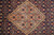 Close up of salmon diamond medallion with ivory sawtooth outline and teal rosettes